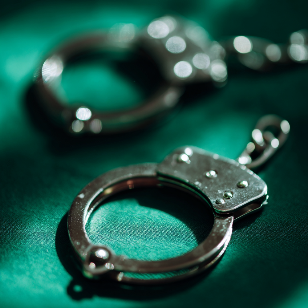 qwwrty5251_stock_photo_handcuffs_law_deep_green_color_accents_fc5d734f-2e88-484d-81e9-a7321946668c_0